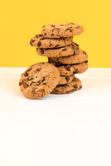 Sticker - Vertical shot of stacked cookies isolated on yellow and white background