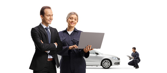 Poster - Male customer and a female car mechanic looking at a laptop computer