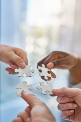 Poster - Joining together as a team. Shot of hands putting puzzle pieces together.