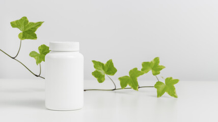 Banner with mockup medical bottle of pills or vitamins with green leaves at the background, organic medication, copy space