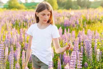 Happy teenage girl smiling outdoor. Beautiful young teen woman resting on summer field with blooming wild flowers green background. Free happy kid teenager girl childhood concept