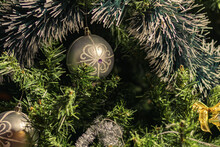 Multicolored Christmas Decorations On Background Of Green Branches Of Festive Christmas Tree.