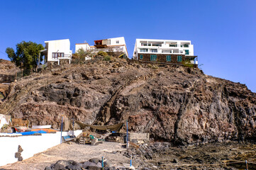 White buildings on the top of the cliff.