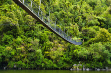 Footbridge For Hikers Over The Otaki River In The Otaki Forks Area Of Tararua Forest Park, Kapiti Coast District, North Island, New Zealand, An Area With Dense Rainforest. Low Camera Standpoint.

