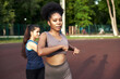 © etonastenka - Training stretching the muscles in the fresh air. Two beautiful fitness females doing stretch exercises by stretching their arms Fitness and lifestyle concept