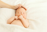 Fototapeta  - Close up portrait of infant sweet sleeping on white bed at home