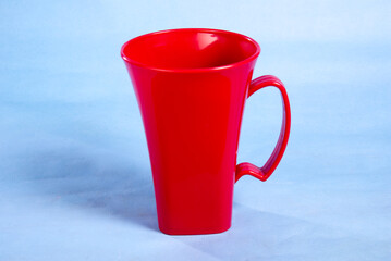 red color empty cup isolated on light blue background