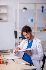 Wall Mural - Young male chemist working at the lab