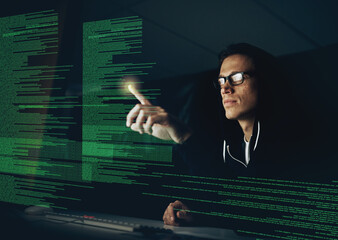 Wall Mural - Hacking your system one touch at a time. Cropped shot of a young hacker cracking a computer code in the dark.