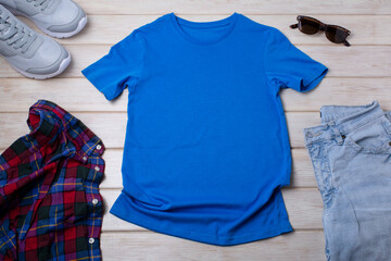 Unisex blue T-shirt mockup with trainers and jeans