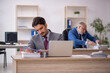 © Elnur - Two male colleagues working in the office