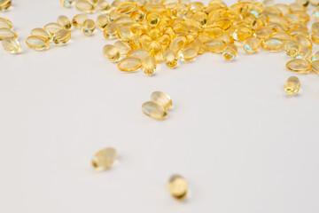 Scattered vitamin d pills on white background