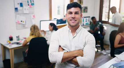 Poster - Were in it to win it. Portrait of a confident young businessman working in a modern office with his team in the background.