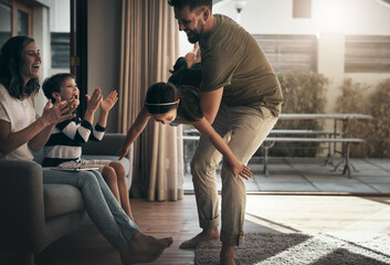 Wall Mural - Theres always time for family. Shot of a happy young family spending quality time together at at home.