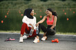 © prostooleh - Two black women holding a bottles with water after doing workout