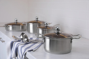 Set of new clean cookware and utensils on countertop in kitchen