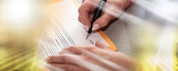 Hand of businesswoman signing a document; multiple exposure