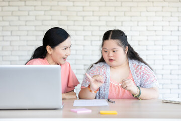 Wall Mural - down syndrome teenage girl studying math and counting on fingers with her teacher on a table