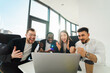 © Andrii  - Group of business partners sit in front of a laptop and rejoice in the success of their company