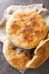 Canvas Print - Freshly baked Ukrainian homemade palyanitsa bread close-up on the table. Vertical top view from above