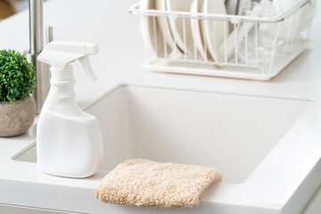 Poster - Cleaning product spray bottle in modern kitchen beside sink.