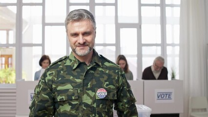 Wall Mural - Portrait of soldier in military uniform attaching vote pin at polling station