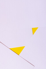 Sticker - geometric background with lavender paper sheets and yellow triangles.