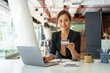 © Phushutter - Young Asian woman looking to camera, holding credit card and using laptop computer, Online shopping, e-commerce, internet banking, spending money concept.