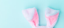 Toy Bunny Ears On A Blue Background. The Concept Of The Easter Holiday, Flat Lay. Minimalism. Banner