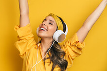 Delighted Woman Listening To Music In Headphones