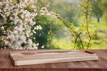 Wooden Table In Front Of Spring Blossom Tree Landscape. Product Display And Presentation