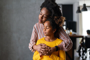 Wall Mural - Portrait of african american mother and daughter loving each other , hugging together