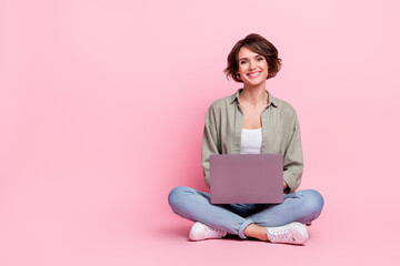 full size photo of cheerful charming lady sit look camera toothy smile isolated on pink color backgr