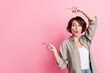 Photo of impressed young bob hairdo lady indicate promo wear grey look isolated on pink color background