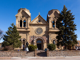 The facade of the 1887 romanesque revival Cathedral Basilica of Saint Francis of Assisi in downtown Santa Fe, New Mexico, USA