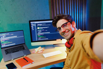 close up young smiling software database engineer it specialist programmer man in shirt work at home