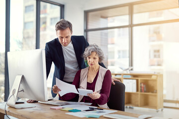 They make logical, informed decisions. Shot of two businesspeople working together in an office.