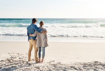 Poster - Getting lost in the beauty of nature. Shot of a middle aged couple spending the day at the beach.