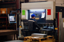 Technician Operator Working With With Sheet Metal On CNC Hydraulic Press Brake