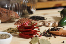 Dried Peppers With Spices And Jars Of Rice In Background In Rustic Kitchen