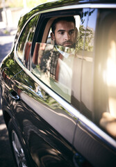 Poster - On his way into work. Cropped shot of a handsome young businessman on his morning commute to work.