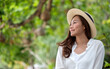 © Farknot Architect - Portrait image of a beautiful young asian woman in white shirt with hat relaxing in the park