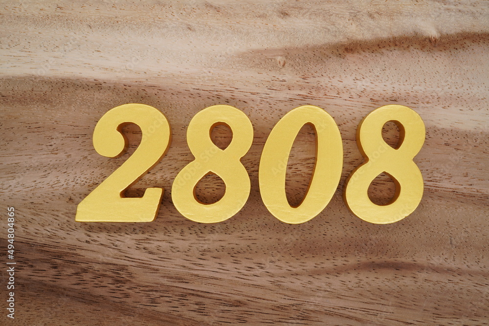 Golden Arabic numerals on a real brown and white wooden floor number ...
