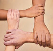 © Jade M/peopleimages.com - Support first, succeed second. High angle shot of a diverse group of businesspeople holding each others wrists in the office.