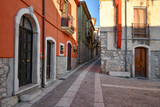 Fototapeta Uliczki - A narrow street among the old stone houses of Taurasi, town in Avellino province, Italy.