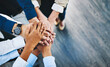 © Delmaine Donson/peopleimages.com - Together on their mission as a team. Shot of a group of unrecognisable businesspeople joining their hands together in unity in an office.