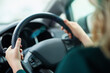 © Camerene P/peopleimages.com - Journeying along. Shot of a woman holding onto a steering wheel while driving.