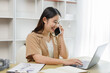 © Pichsakul - Online lifestyle concept A female employee talking with her client with warm welcome while typing the order on the laptop.