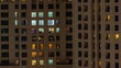 Evening view of exterior apartment recidential building timelapse with glowing windows