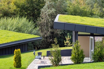 A modern village with turf roofs. Scandinavian type of green roof covered with sod on top.